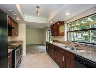 Kitchen remodel with all wood cabinets and granite countertops.