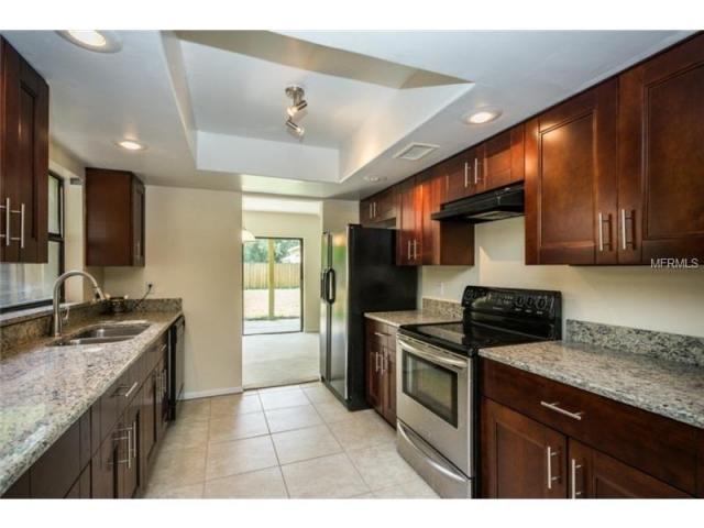 Kitchen remodel with all wood cabinets and granite countertops.