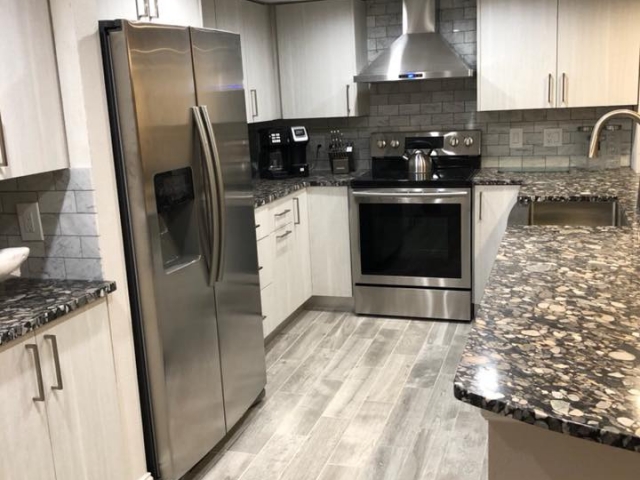 Totally remodeled kitchen with new all wood cabinets and granite counter tops.